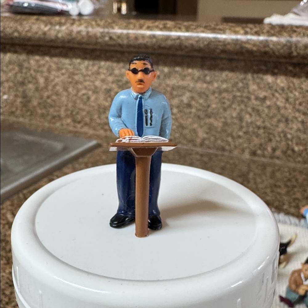The product is a collectible figurine of "El Profe" from the Lil Homies Series 5